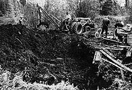 Backhoe removing peat layer